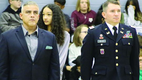 Taylor ISD teacher Armando Talavera (left) and school board member Joe Meller are recognized during the Taylor Middle School Veterans Day tribute. Photo by Jason Hennington