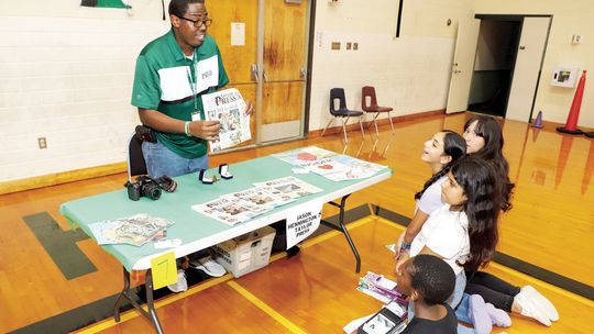 Students learn more about the Taylor Press and what it takes to produce a newspaper from Area Editor Jason Hennington during Career Day at Main Street Intermediate. Photo by Tim Crow