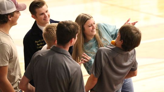 Thrall FFA Vice President Ty Bradford, 10th, attempts to pass an orange to Stephanie Widner, 10th, without using his hands as State FFA officer Bryce Fisher and FFA members Dawson Meiske, Maverick McAllister, and Anson Gonzales cheer them on.