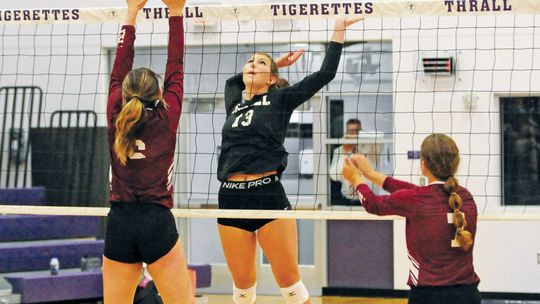 Thrall High School varsity volleyball freshman Ellie Schmidt goes up high to spike on Aug. 22 during the Tigerettes’ home match victory vs. Troy High School. Photos by Larry Pelchat