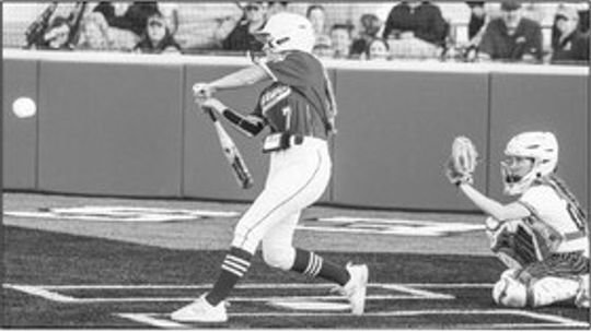 Autree Kelm steps into a pitch and sends the ball to deep right field for an extra base hit. Photo by Larry Pelchat