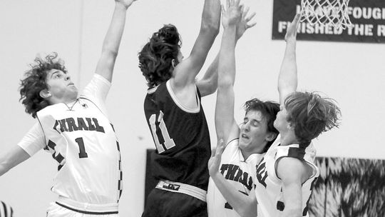 Tigers converge on a opposing player attempting to block a shot. Photo by Larry Pelchat