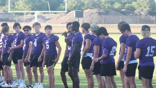 Thrall High School varsity football senior, Steven Walker  (center) introduces himself and his team 