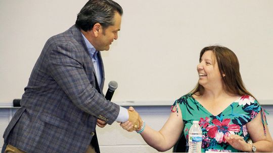 Jim Buzan (left) shakes hands with his opponent Lisa Baum after the candidate forum hosted by the Taylor Press and the Greater Taylor Chamber of Commerce.