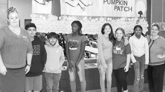 Taylor Middle School Counselors and a few seventh-grade students take a moment from reading notes of gratitude written by classmates and colleagues to take a photo with the display. From left are Counselor Melissa Smith, Santiago Hall-Albavera, Andrew Hernandez, Amerius White, Trinity Kell...