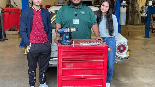 Taylor High School students Mustafa Alsabhawe and Melanie Quininez, and TISD staff member Jonathon Capetillo, accept the gift of a tool chest full of tools for the automotive department. The donation was made by Greg and Gennifer Tvrdik. Courtesy photo