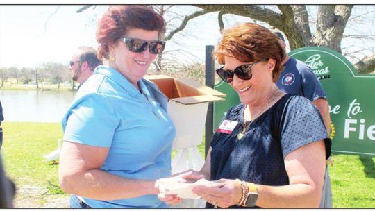 Tia Rae Stone, left, and Stacy Stork look at donations submitted by the Rotary Club of Taylor to the Salvation Army March 25 in the wake of area tornadoes. Photo by Fernando Castro