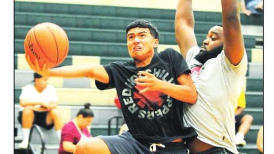 Anthony Baron goes up past Cordez Maddox in a game at last year’s Taylor Press 3-on-3 Basketball Tournament. Photo by Larry Pelchat