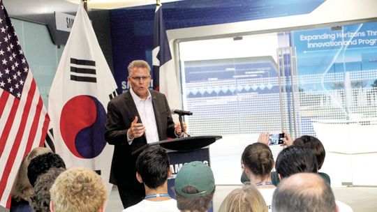 Williamson County Judge Bill Gravell speaks in front of Samsung Austin Semiconductor’s Taylor interns. Gravell was a driving force of ensuring the school district would gain an internship program for its students. Photos by Hunter Dworaczyk