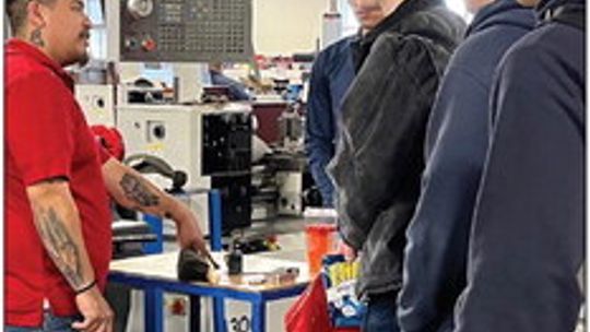 Apolinar Ruiz (left), lead instructor in Texas State Technical College’s Precision Machining Technology program at the East Williamson County campus, talks to high school students attending the campus open house Friday, March 3, at the East Williamson County Higher Education Center. Photo...