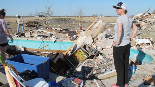 Sharrion Threadgill looks over some of the remains of her Granger-area home March 24, three days after a tornado tore through their family’s home. Photo by Fernando Castro