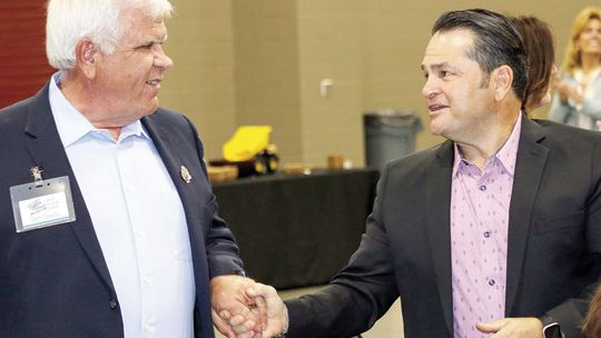 Jim Buzan (right) congratulates Sam Dowdy as he heads to the front to accept the Rotary Citizen of the Year award. Photos by Jason Hennington