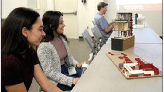 (From left) UT architecture students Nikki Gendelman and Nataly Serrano prepare to present their preliminary designs for a wellness center in Memorial Park Feb. 15 to their classmates as well as city staff and other interested community members at the parks and recreation facility at Davis...