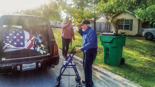 John Gipson (back) takes a photo as Espirririon “SP” Santa Cruz salutes a fellow member of the military who served in the Korean War, a conflict Santa Cruz also served in. Courtesy photo