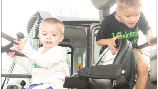 David Crockett, 6, gets in the driver’s seat of tractor at the Truck Petting Zoo in Taylor March 17, while Michael Crockett, 2, also occupies the vehicle. Photos by Fernando Castro