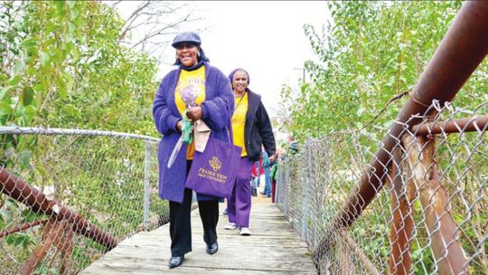 In 2018, members of the Blackshear/O.L. Price Ex-Students Association lead the way across the Dickey Bridge. File photo