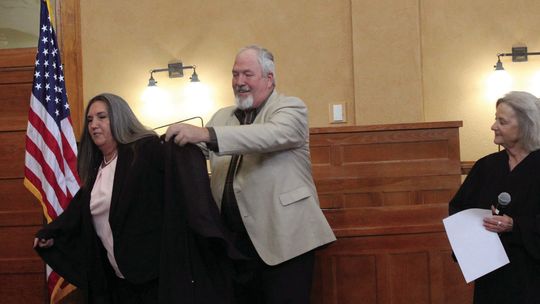 Rhonda Redden puts on her new judge’s robe with the assistance of husband Greg as Judge Edna Staudt looks on during the swearing-in ceremony for Williamson County elected officials Jan. 1 at the Williamson County Courthouse. Courtesy photo