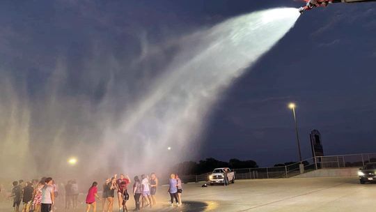 Taylor High School Band and Color Guard students celebrate the end of summer practice in the 100 plus degree heat with a visit from the Taylor Fire Department. Courtesy photo