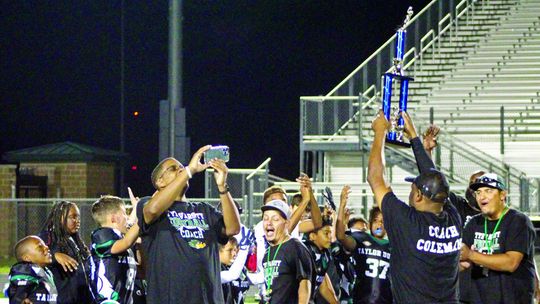 Youth Ducks’ coaches hold up the Tri-County Championship to celebrate with their team. Photos by Evan Hale