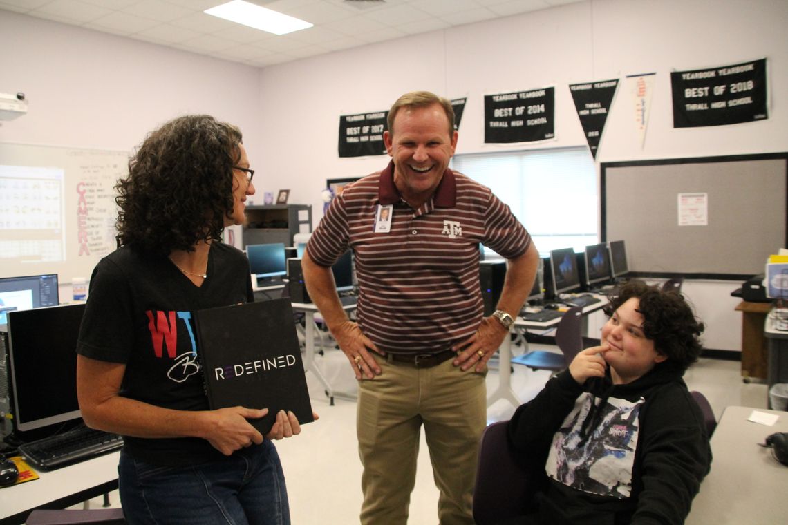 (Left to right) Yearbook Adviser Christina Strnad shows the 2021-2022 Tiger Yearbook Wednesday, Sept. 28 to Superintendent Tommy Hooker and freshman Emma Mendoza at Thrall High School.  