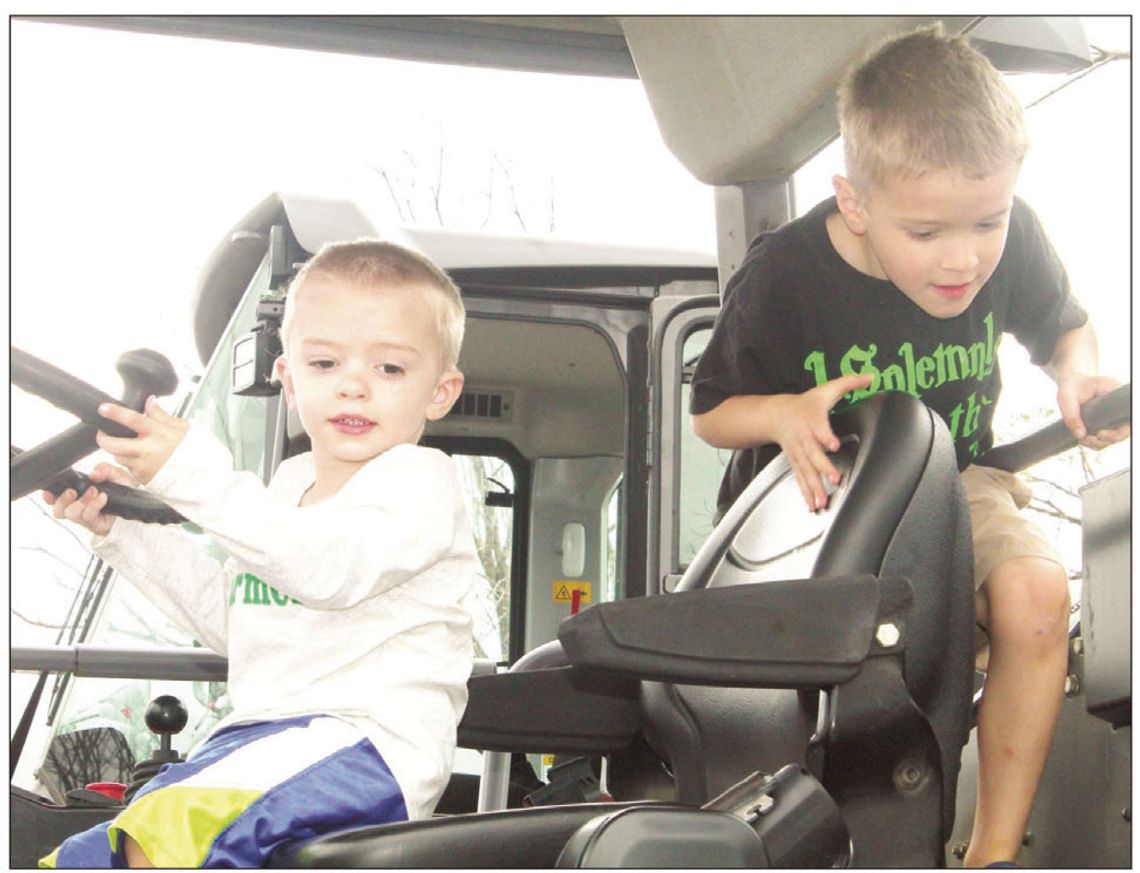 David Crockett, 6, gets into the driver’s seat of tractor at the Truck Petting Zoo in Taylor March 17, 2022 while Michael Crockett, 2, also occupies the vehicle. Photos by Fernando Castro