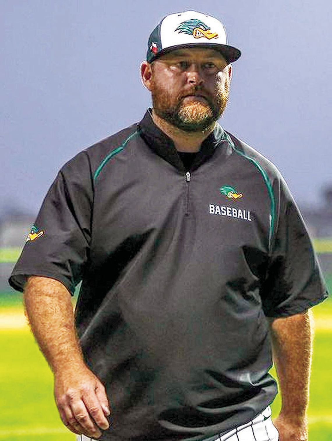 Taylor High School varsity baseball head coach Justin Adams walks off the field on April 4 during the Ducks’ 7-2 home victory over district foe La Grange High School. Photo by Ryan Newsom