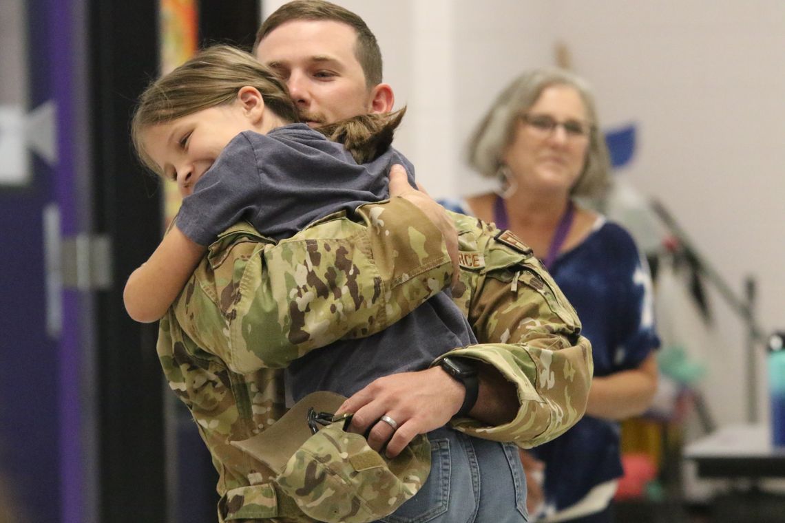 Adilene Saunders, a fourth grader at Thrall Elementary, gets a surprise visit during lunch from her father, Air Force Technical Sergeant Caleb Saunders, who returned home for a weekend visit during his year-long deployment. He also surprised his thirdgrade daughter, Gracelynn, and Jolene w...