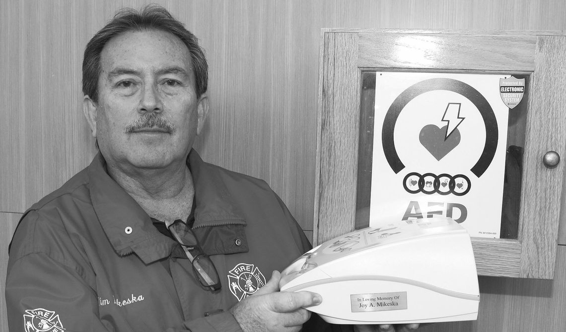 Tim Mikeska holds the AED he donated 16 years ago in memory of his mother, Joy Marshall Mikeska. Photo by Tim Crow