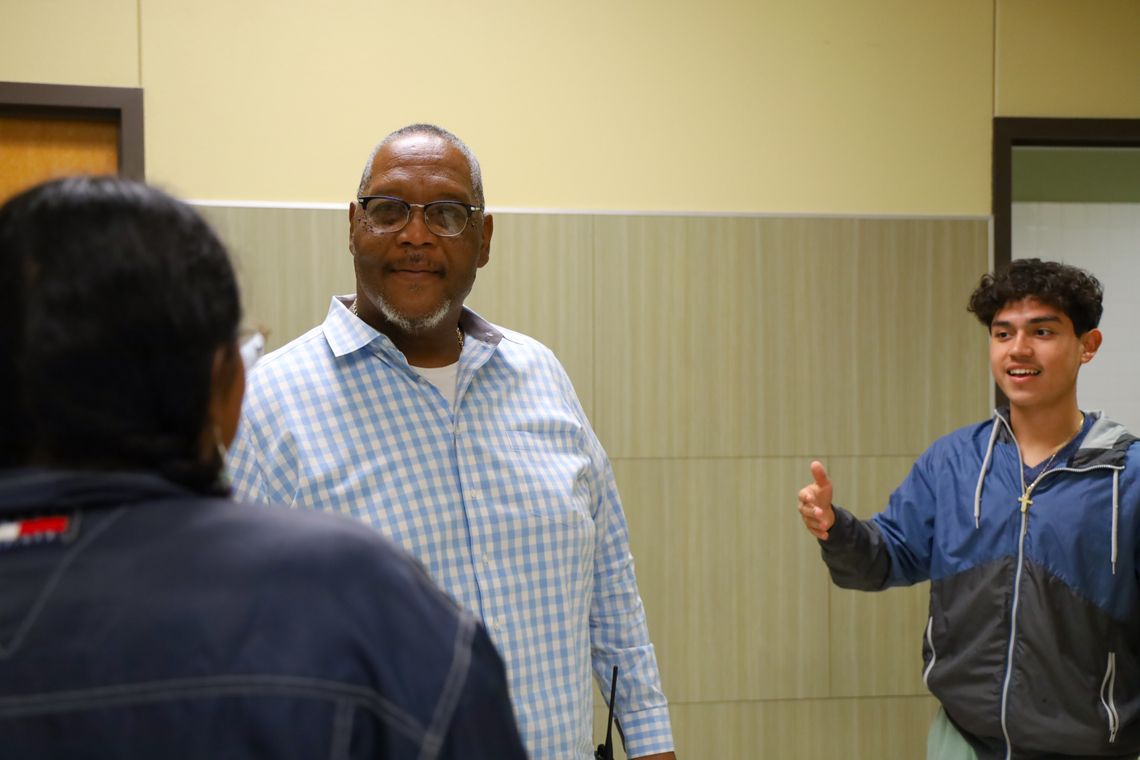 Tommie Garner enjoys a conversation with students while monitoring the hallway at Taylor High School. Photo by Ryan Newsom