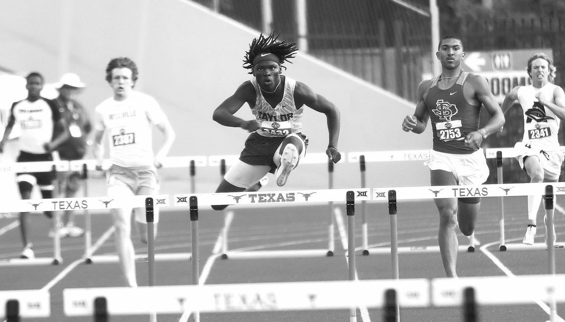 Taylor High School senior boys track and field standout Jarvis Anderson clears a hurdle on May 11 en route to a gold medal in the 300-meter hurdles at the UIL 4A State Track and Field Tournament held at Mike A. Myers Stadium in Austin. Photo by Briley Mitchell