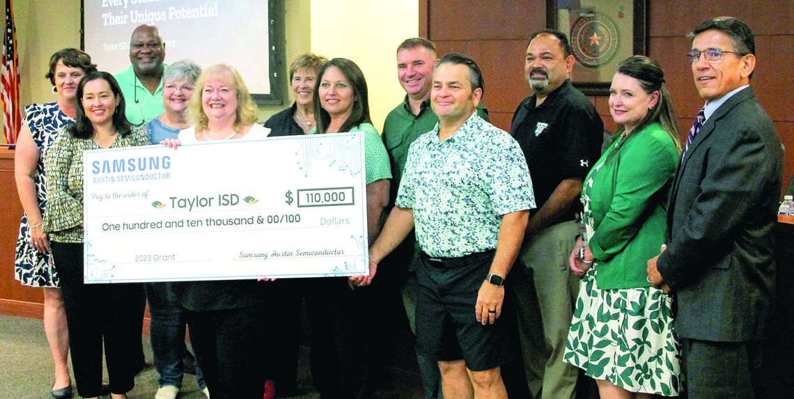 During the Aug. 21 school board meeting, Samsung Austin Semiconductor presented a $110,000 donation. Pictured is the board of trustees, administrative staff and Michele Glaze of Samsung Austin Semiconductor. Photos by Hunter Dworaczyk