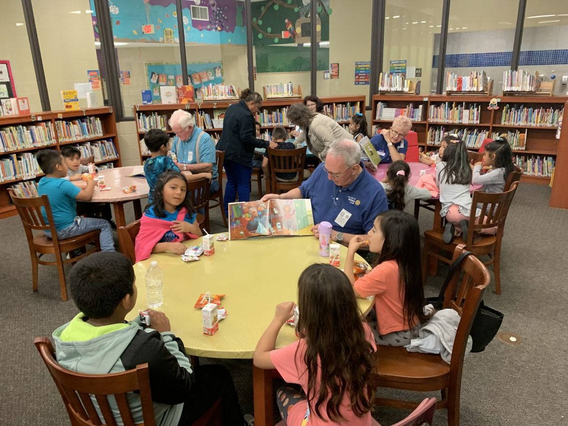 (Clockwise from left) Rotarians Dennis Richter, Cheryl Webster, Kathy Whisenant and George Qualley reading to first grade students at T.H. Johnson Elementary School. Courtesy photo