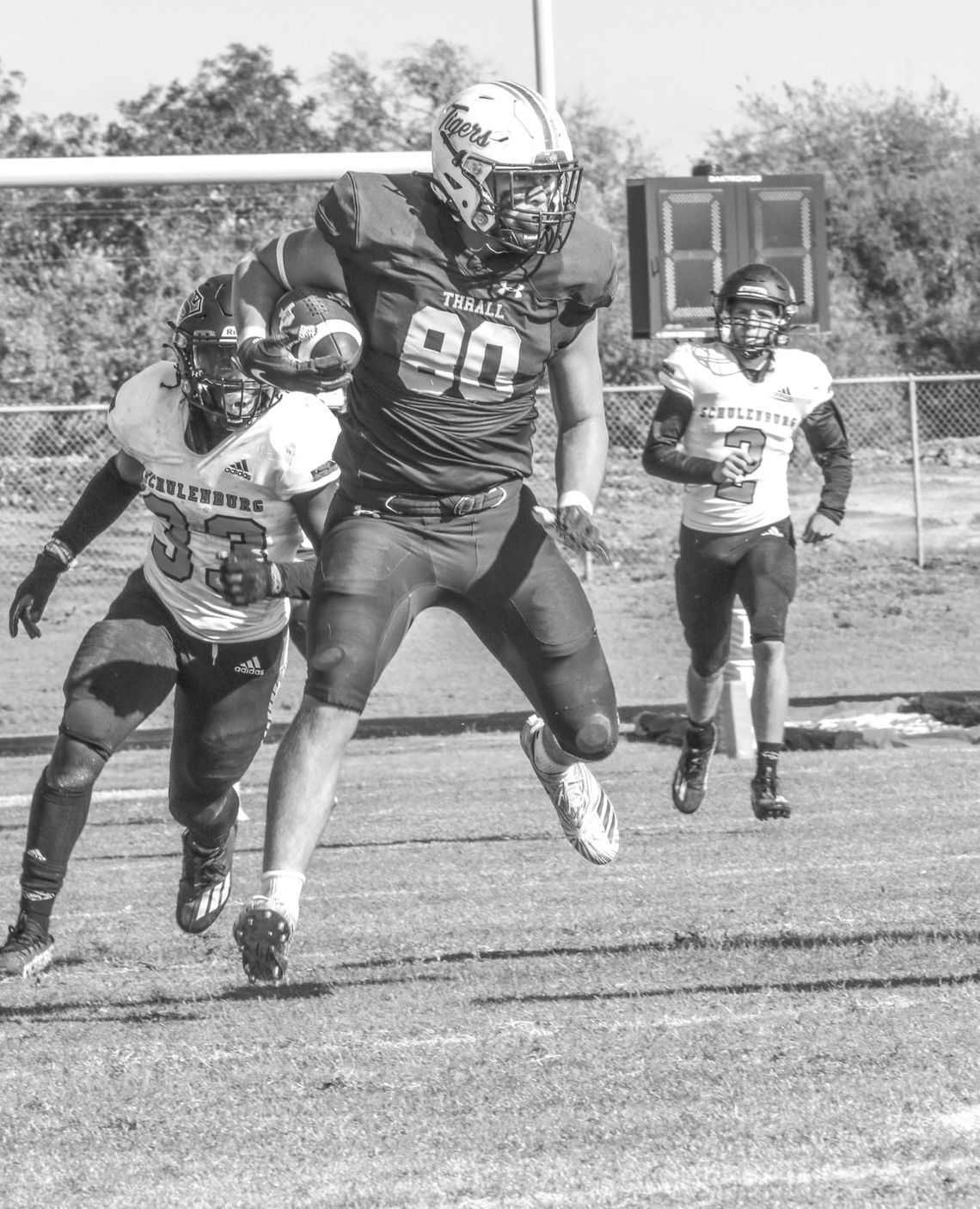 Thrall High School varsity football tight end Tyler Bonkowski runs after the catch on Nov. 5, 2022, during the Tigers’ 38-14 victory at home against Schulenburg High School. Photo courtesy of Thrall Tiger Yearbook