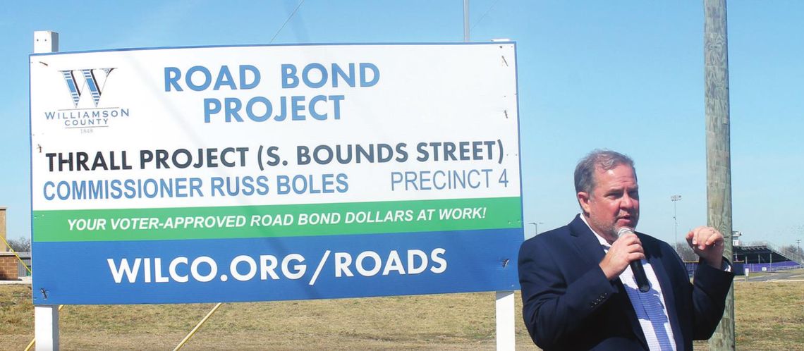 Above: Commissioner Russ Boles addresses residents prior to the ribbon cutting of completed improvements to South Bounds Street in Thrall Feb. 28. Left: Bounds Street runs in front of Thrall Independent School District near the east edge of Thrall. Photos by Fernando Castro