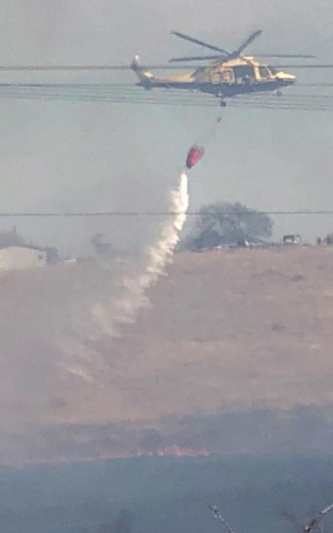 Travis County STAR Flight drops water on a brush fire in south Hutto Jan. 14. Photos by Lt. Mike Pendley