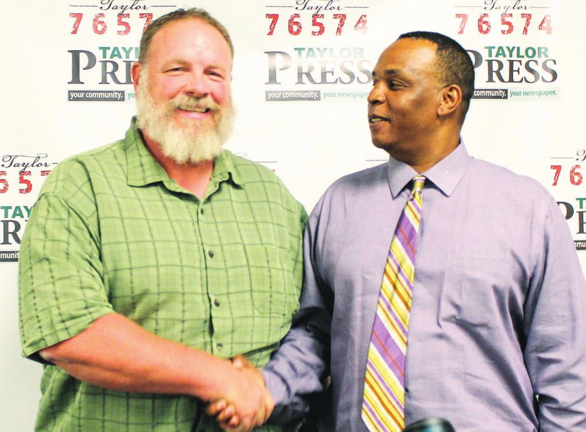 Stan Werner (left) and Gerald Anderson shake hands after the candidate forum at the Taylor ISD Main Streets Event Center in Taylor April 11. Photos by Fernando Castro