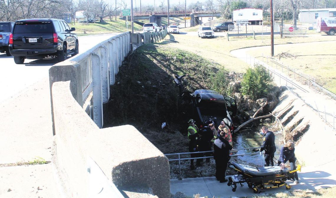 First responders help an injured driver from a vehicle in a ditch underneath Fourth Street and near the City of Taylor Animal Shelter Jan. 6. Photos by Fernando Castro