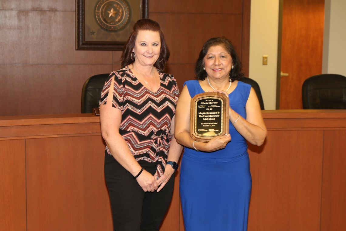 Maria Chavana receives a plaque in honor of her retirement from East Williamson County Cooperative Director Kathryn Wyman.