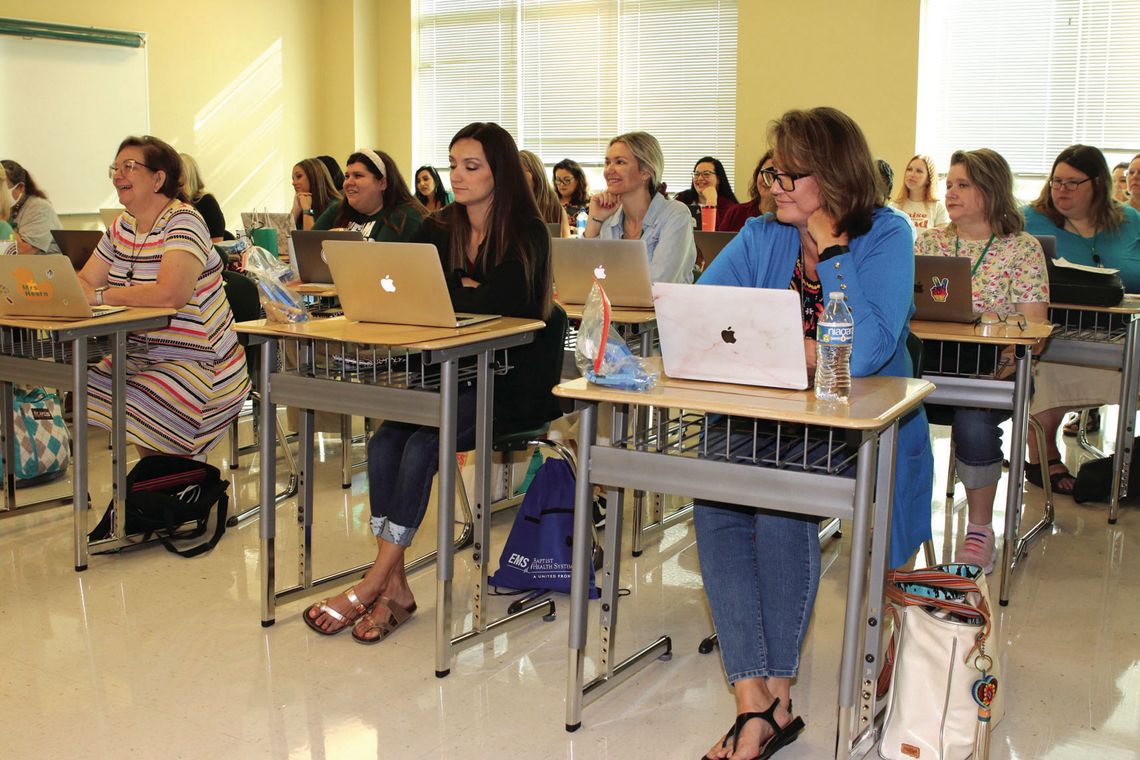 Taylor educators are all smiles as they begin professional development sessions to prepare for a successful year. Photo by Tim Crow