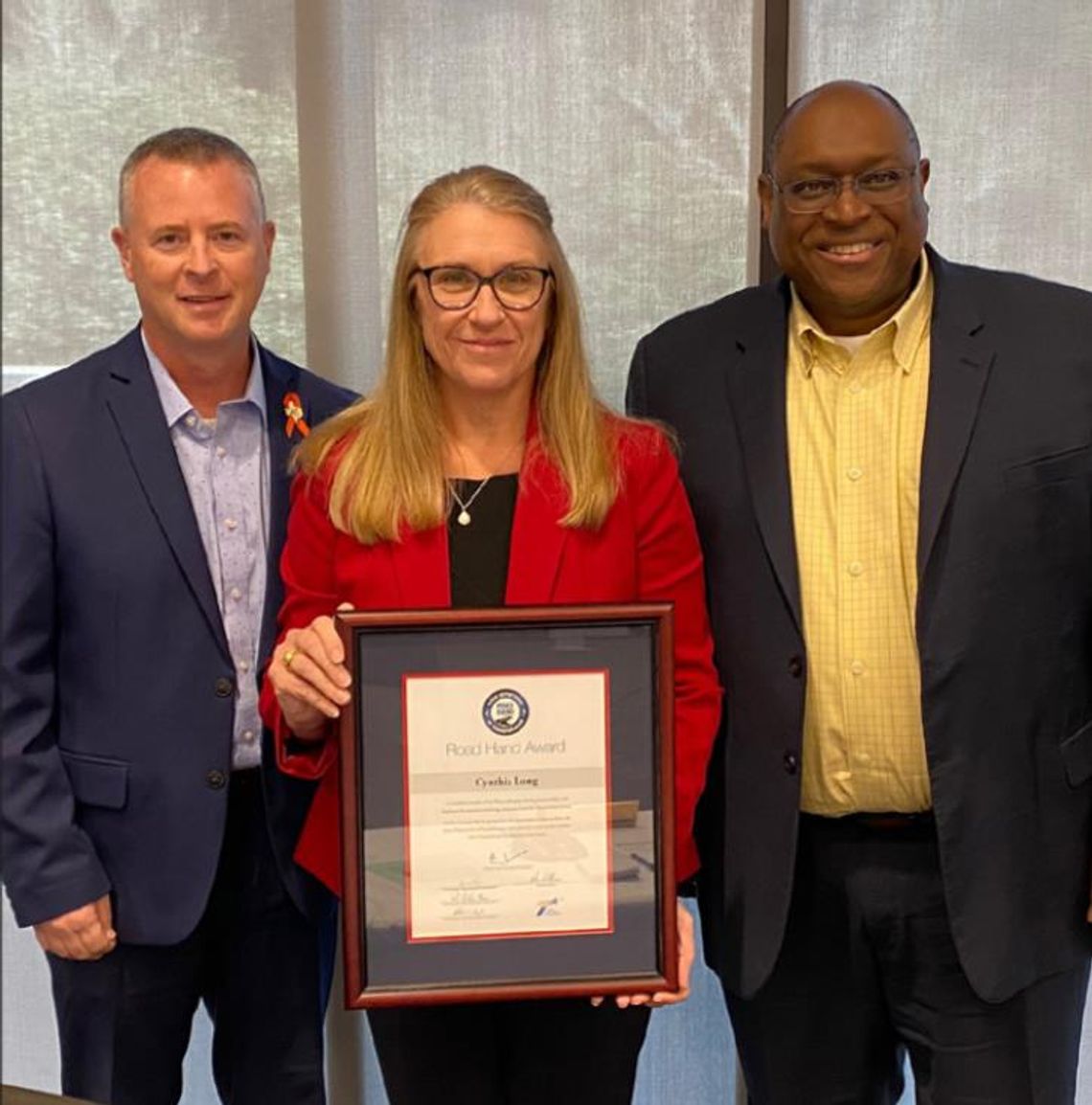 Williamson County Precinct 2 Commissioner Cynthia Long (middle) celebrates being recipient of the 2022 Texas Department of Transportation (TxDOT) Road Hand Award. Also pictured are (left) Tucker Ferguson, TxDOT Austin district engineer, and Ashby Johnson, CAMPO executive director. Courtesy...