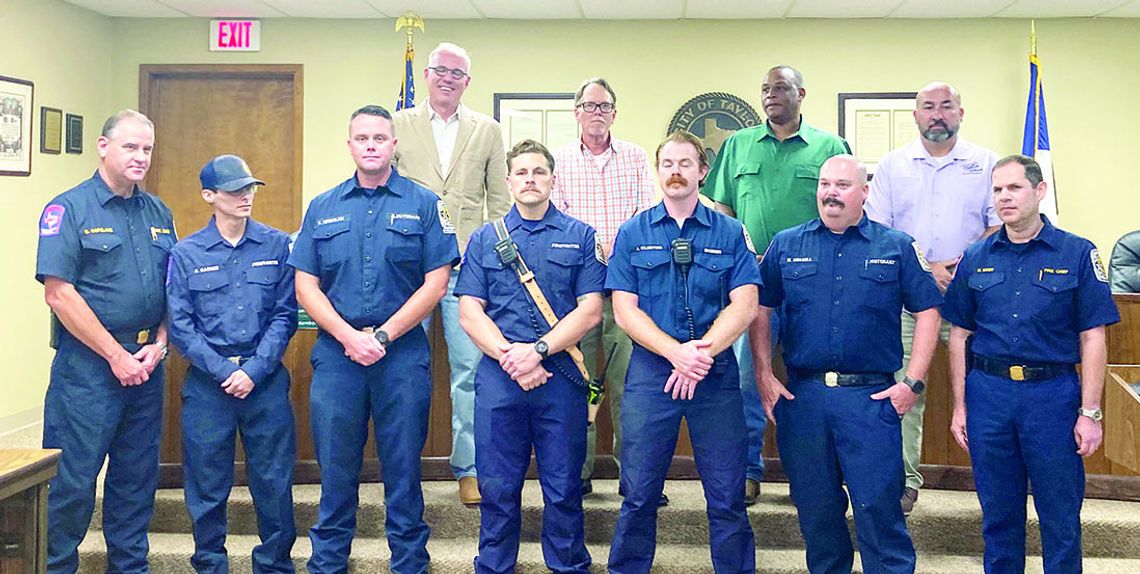 Chief Daniel Baum (right) talks about the heroic efforts of Taylor Fire Department firefighters who worked as a team to complete a dramatic ladder rescue and extinguish a dangerous fire at the Burnett Place Apartments June 5, including Assistant Chief Robert Copeland (left), Lt. Eric Engel...