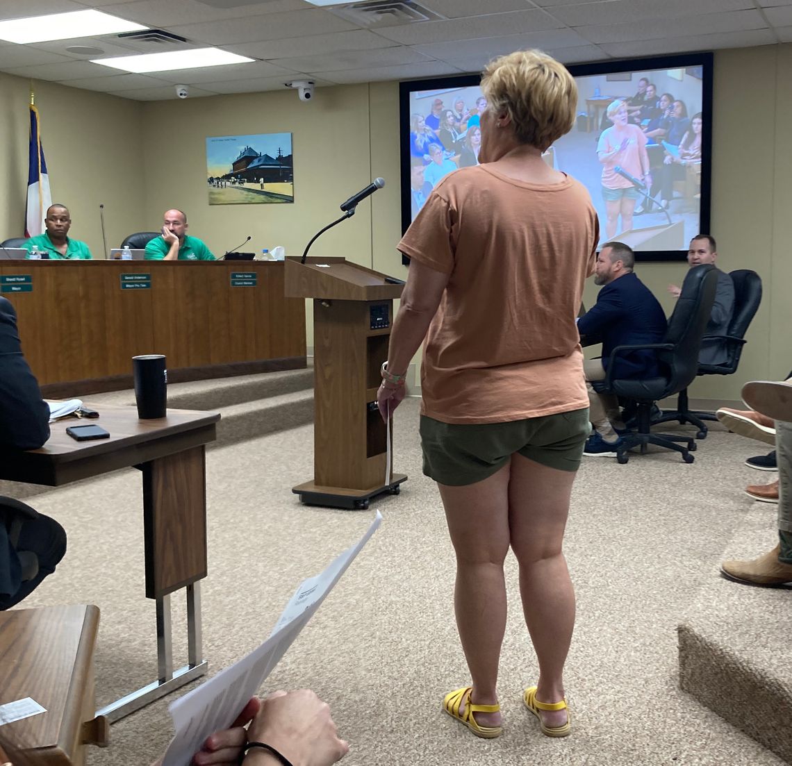 Stacy Stork, a member of a citizens compensation committee, protests the City Council’s split vote to increase their own pay to $1,000 per month and $1,500 for the mayor at the regular meeting July 27.  Photo by Nicole Lessin