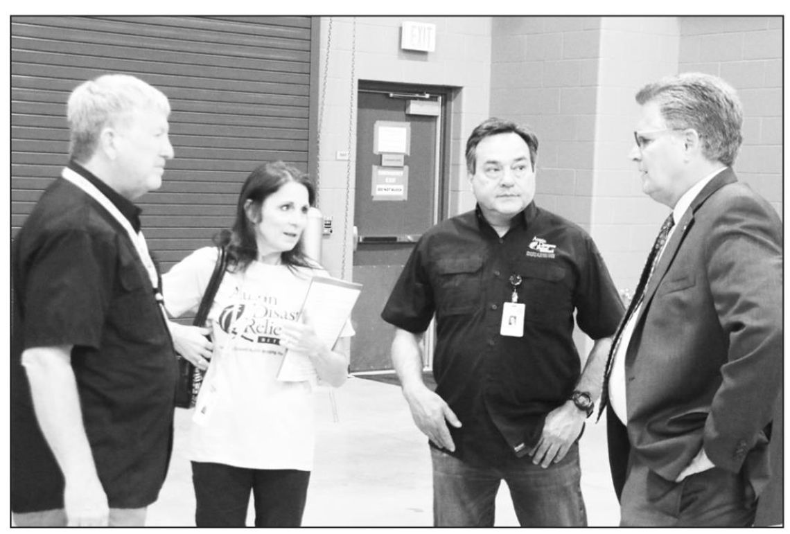 Members of the Austin Disaster Relief Network (from left) Jim Maunder, Gina Maunder and Robert Vidaurri visit with Williamson County Judge Bill Gravell at the MARC Center Tuesday afternoon. Photo by Jason Hennington