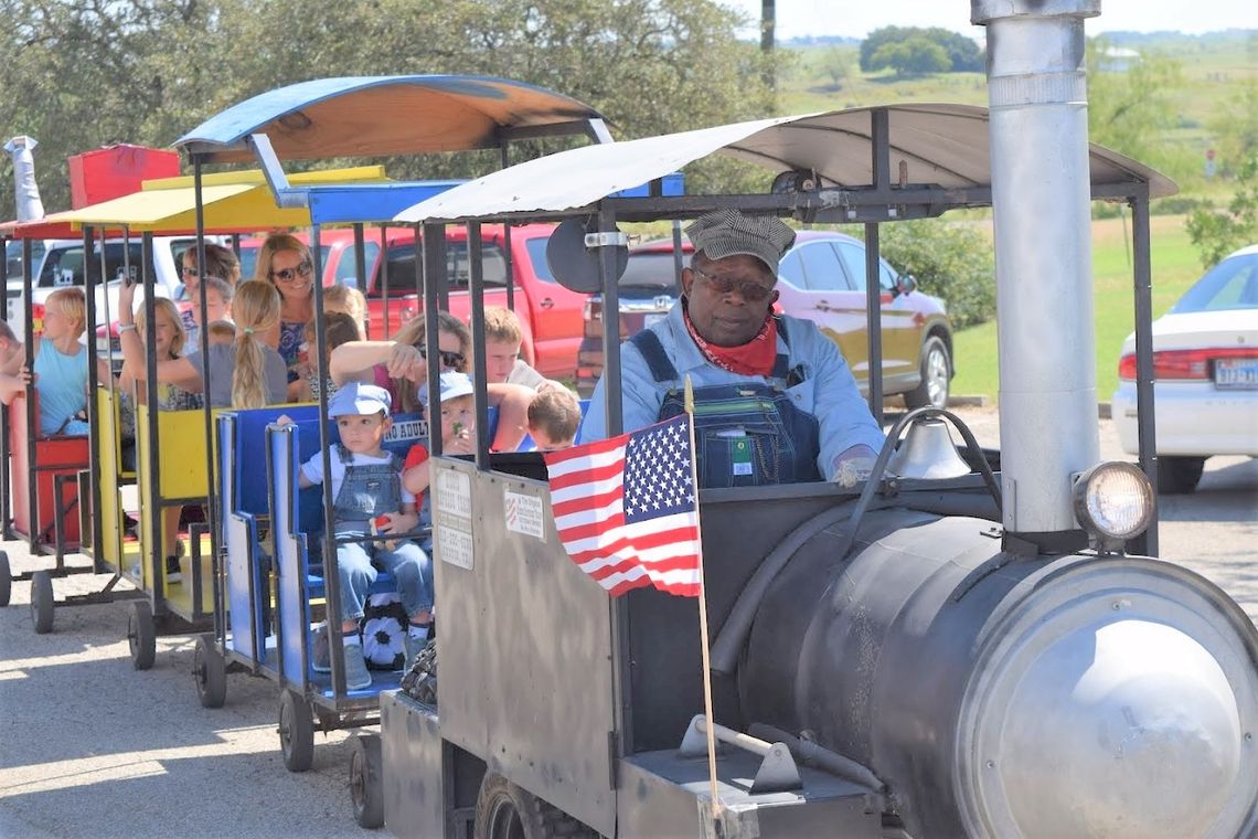 Owner and driver JC Callis drives families around Coupland on the Kiddie Express Train at a past Choo Choo Fest. Photo by Susan Garry