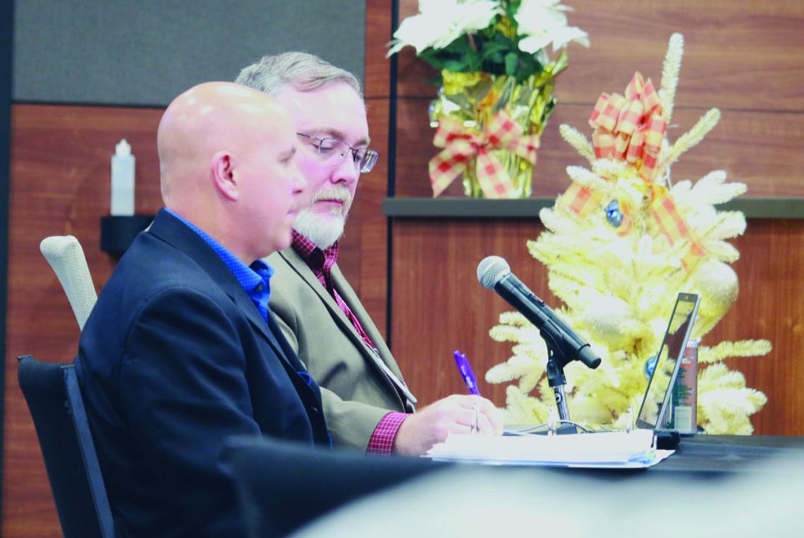 Director of parks and recreation, Jeff White (front) and city manager James Earp listen to city council’s concerns over the concrete contract. Courtesy photo