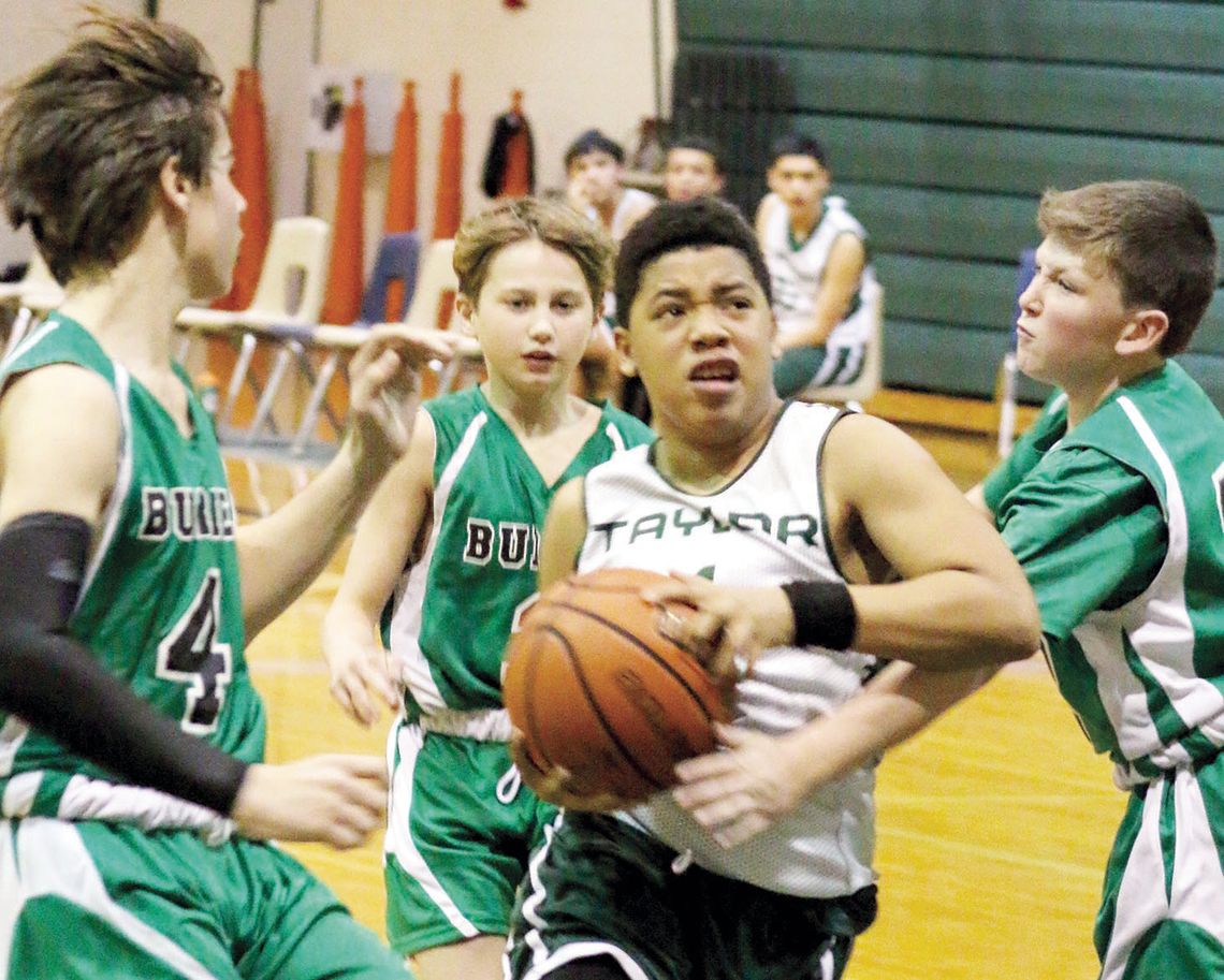 Yonair Guzman fights through defenders and takes the ball to the bucket in the A team’s final home game of the season. Photos by Jason Hennington