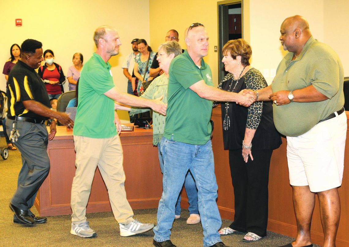 Carl Caldwell (left), soccer coach John Brockway (middle) and Dan Dixon are greeted with thanks and appreciation from the Taylor School Board for their quick actions and efforts in keeping the boys soccer team safe in their travels to a recent game. Photos by Tim Crow