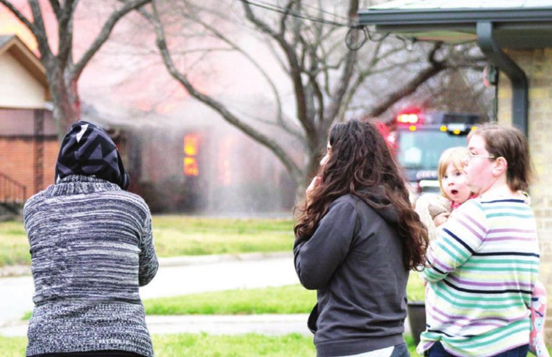 Onlookers watch firefighting efforts on James Street in Taylor March 8. Photo by Matt Hooks