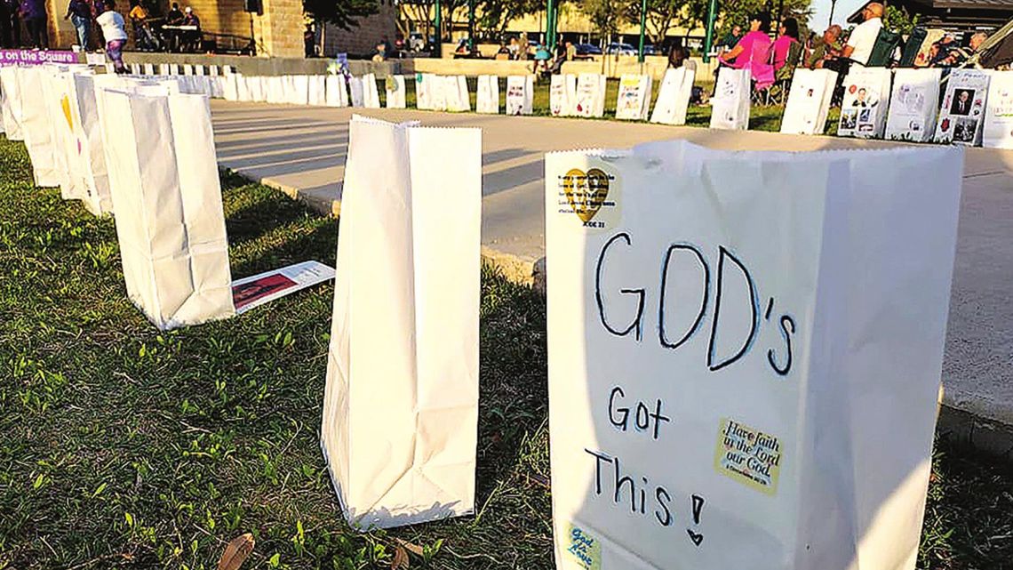 Luminaries lined the sidewalks of Heritage Square April 22 to honor, encourage and remember those who have been impacted by cancer. Photo by Jason Hennington