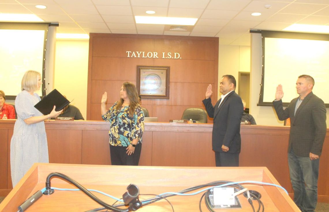 Vicki Roth (left) administers the oath of office for returning and new Taylor ISD board members Cheryl Carter, Marco Ortiz and Joseph Meller during the board’s meeting in Taylor May 16.